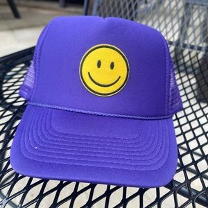 Purple smiley face trucker hat